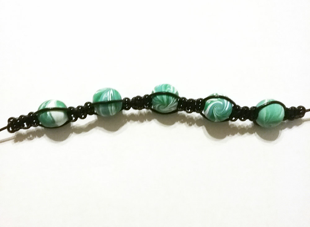 Beads woven into a macrame bracelet