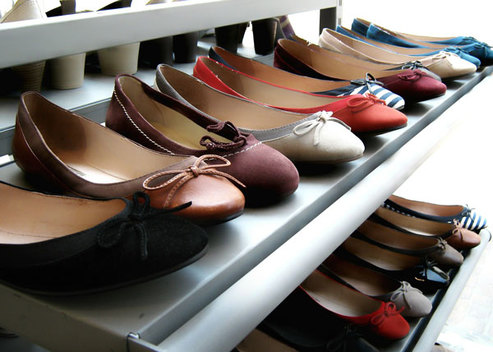 Racks of women's shoes waiting to be rhinestone