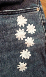 White daisies painted and jeans leg