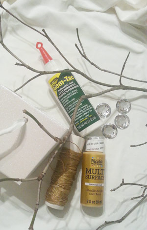 Supplies needed to make a rhinestone twig table centerpiece