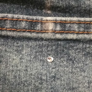 Gluing rhinestones to denim jeans