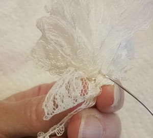 Securing the ends of the bow with craft wire for an Easter door hanging