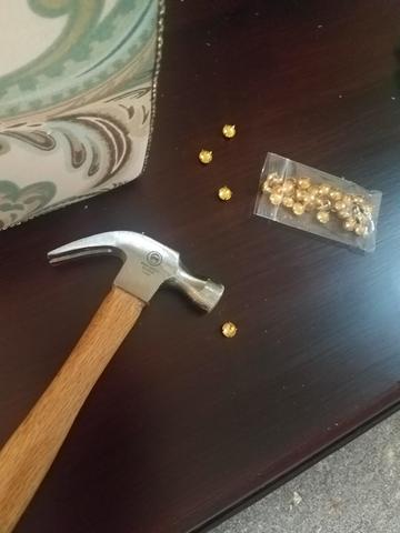 Hammering nailheads on trim in upholstering seat