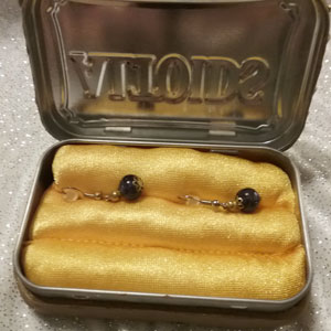 Altered Altoid tin covered with oven baked clay and rhinestones
