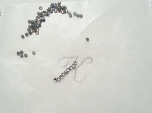 Laying out 6ss rhinestones on wax paper for iron on