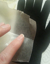 Put wax paper between glove layers when gluing rhinestones