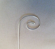 bending the wire into a swirl shape for pendant