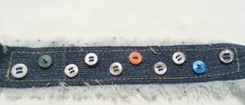 Sewing buttons on denim cuff bracelet