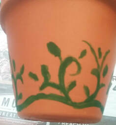 Painting vines on a terra cotta pot