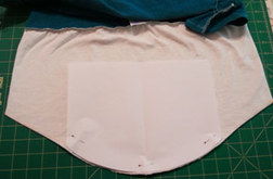 Using a template to cut a rounded edge on the tee shirt 