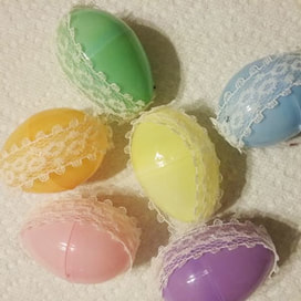 Plastic eggs with lace glued on opposite sides