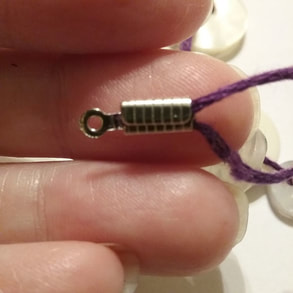 Attaching cord end caps to bracelet for button bracelet