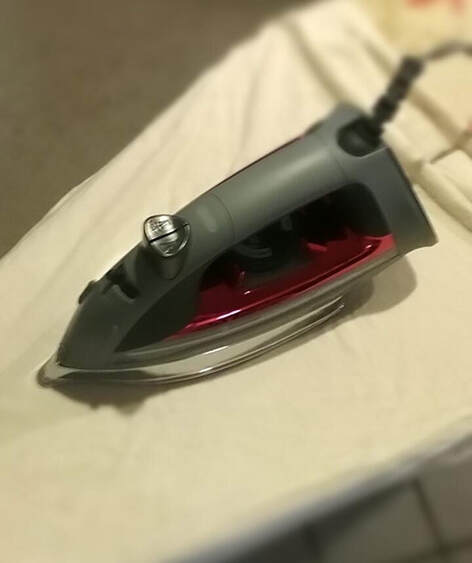 Iron on an ironing board