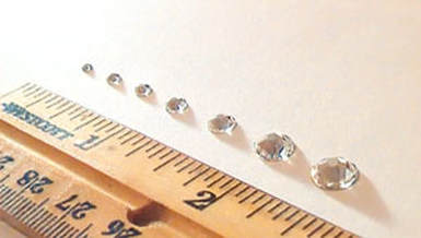 different size rhinestones line up next to a ruler