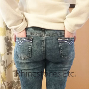 Back pockets of denim jeans with rhinestones