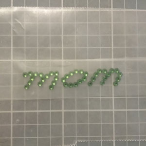 Laying rhinestones out on wax paper to get spacing